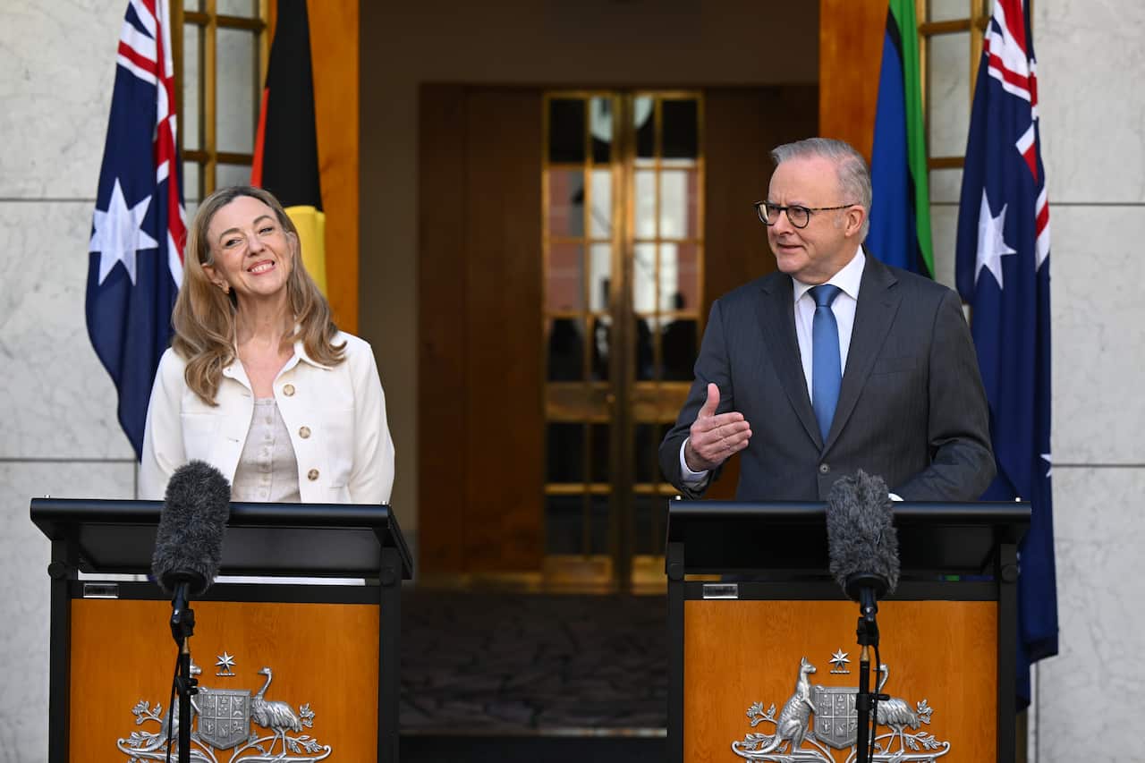 Tammy Tyrrell and Anthony Albanese standing at separate podiums in front of Parliament House.