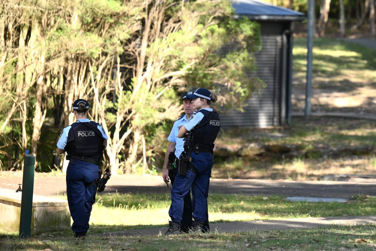 Three police officers in uniform standing outside