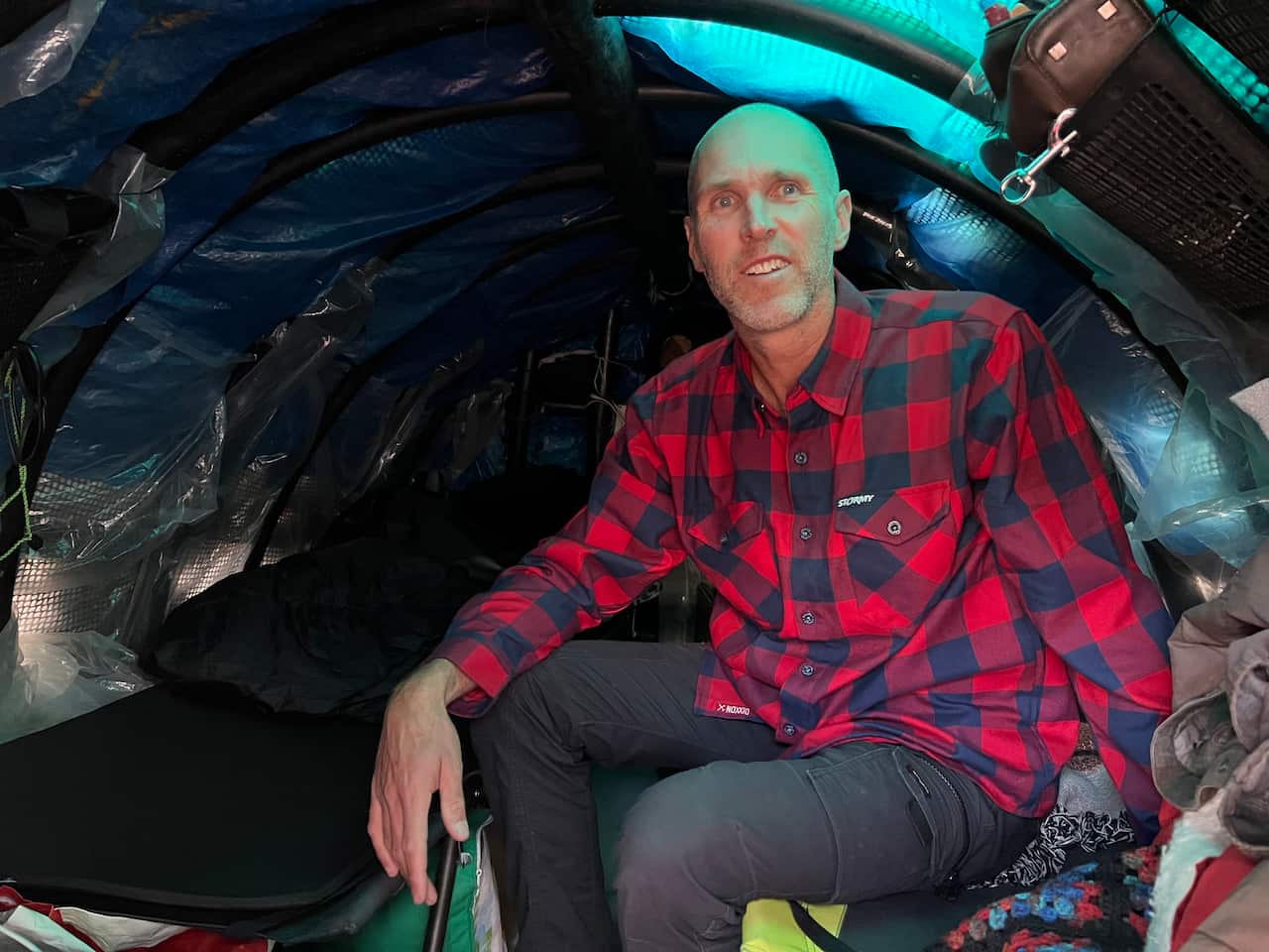 A man sits in a boat cabin