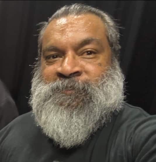 A close-up of a man's face with a white beard.