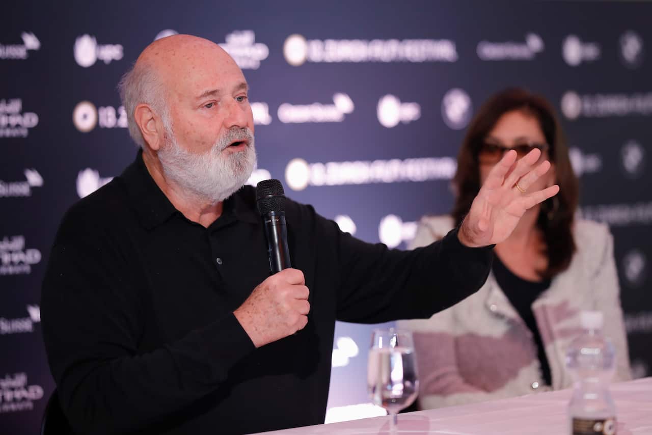Rob Reiner speaking into a microphone