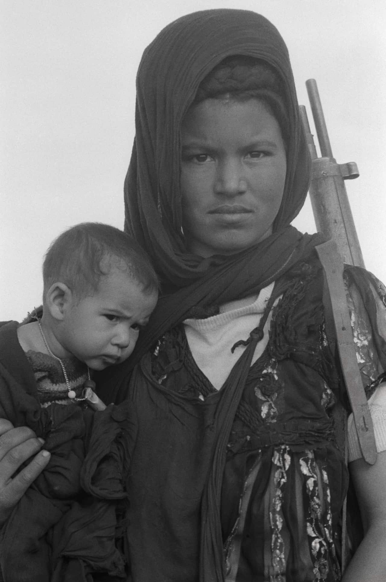 Woman with Rifle and Baby