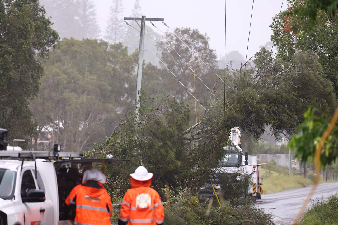 Emergency workers looking at damaged power lines