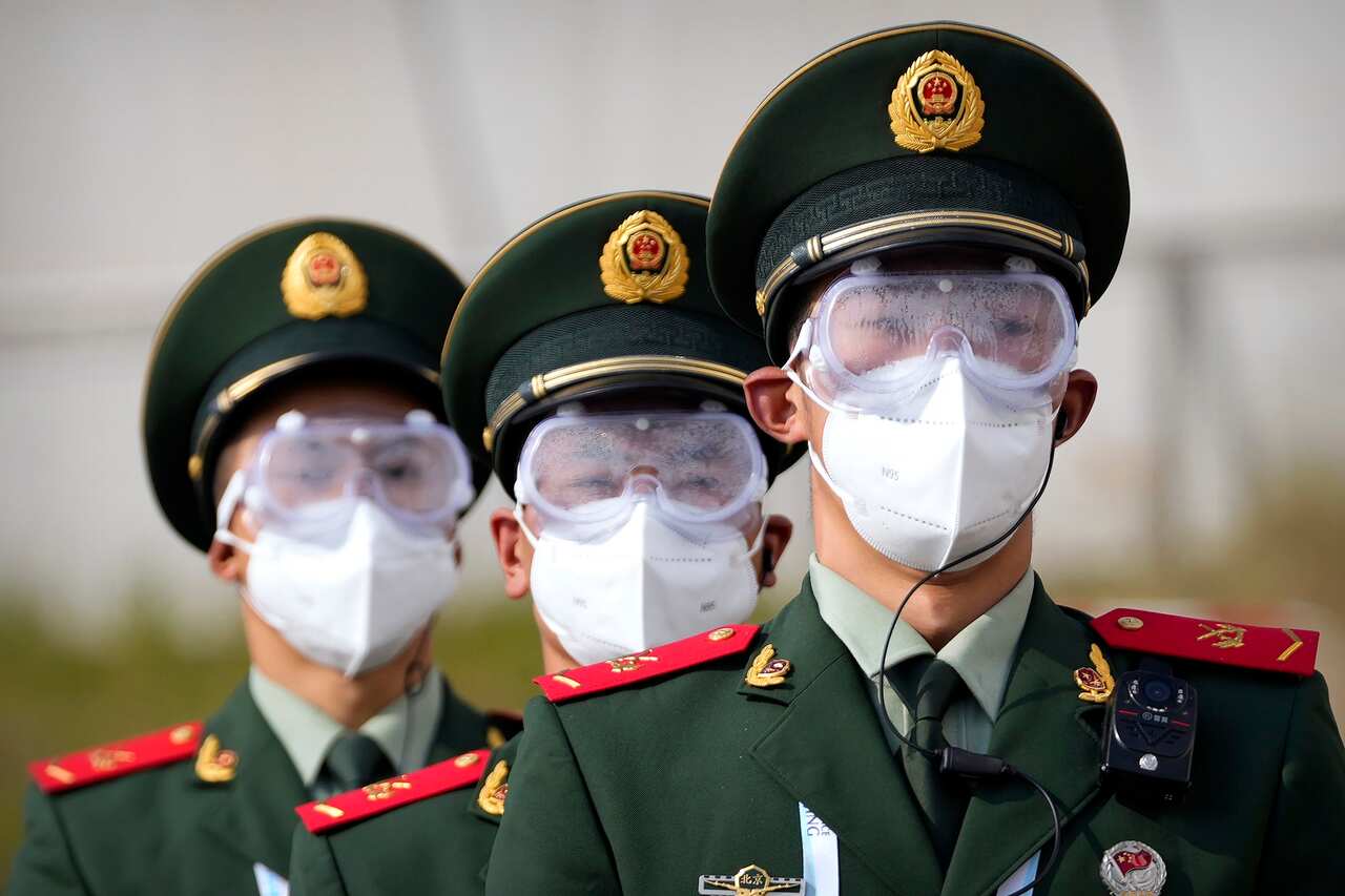 Chinese paramilitary police wear goggles and face masks at the Yanqing National Sliding Center during a test event for the 2022 Winter Olympics in Beijing on 25 October 2021.  