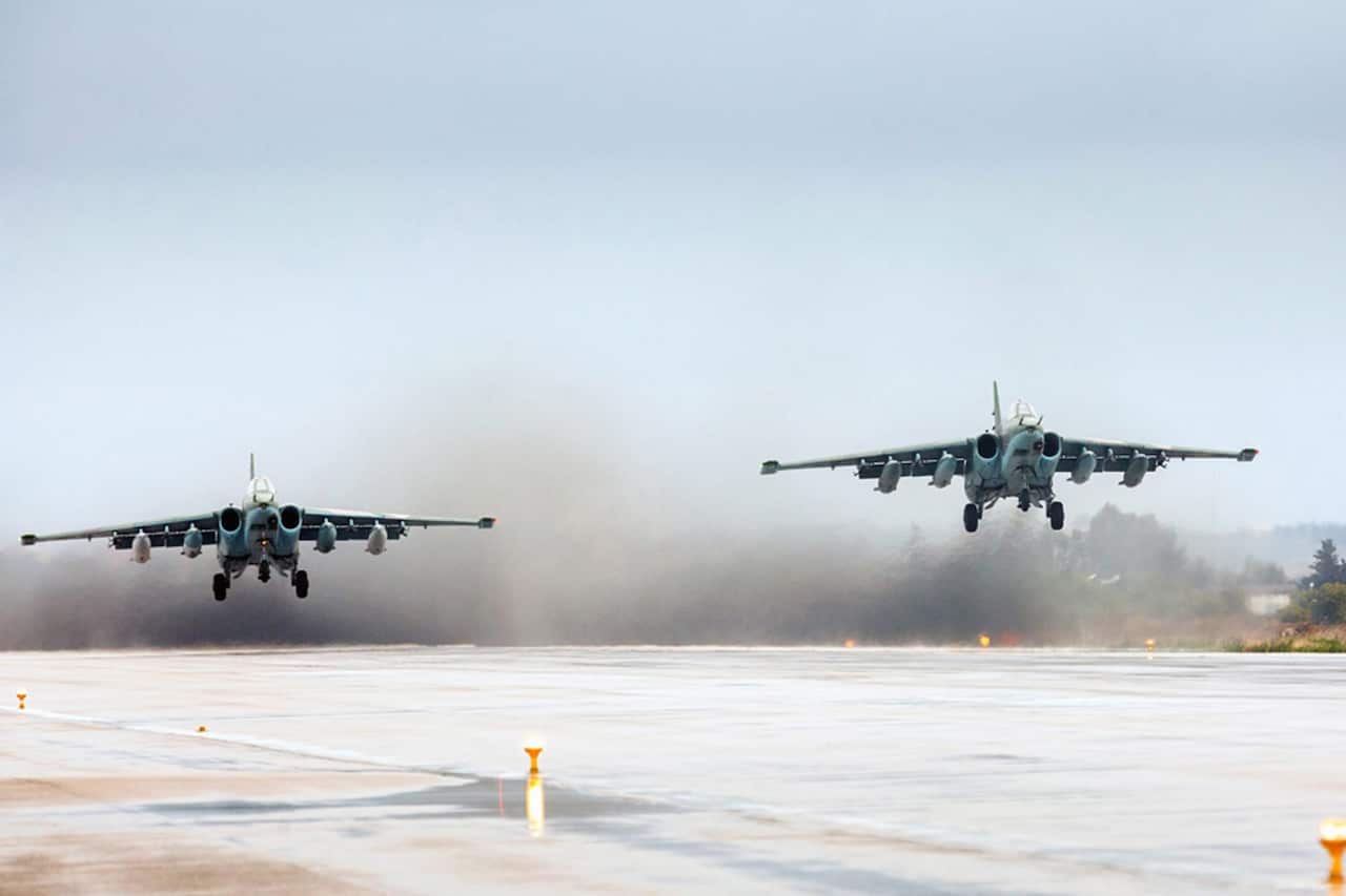 Two fighter jets during take off.