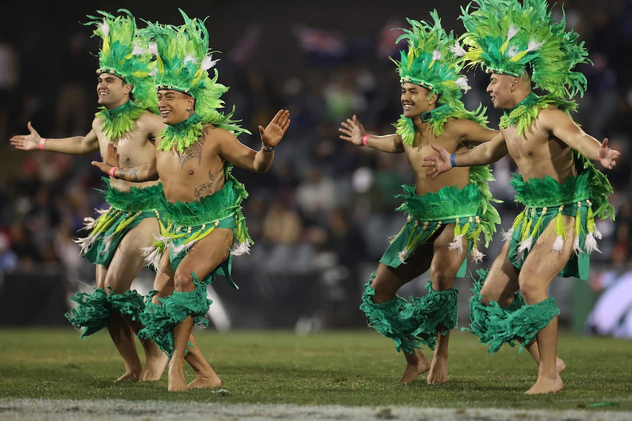 Cook Islanders perform a cultural dance on the football field. 