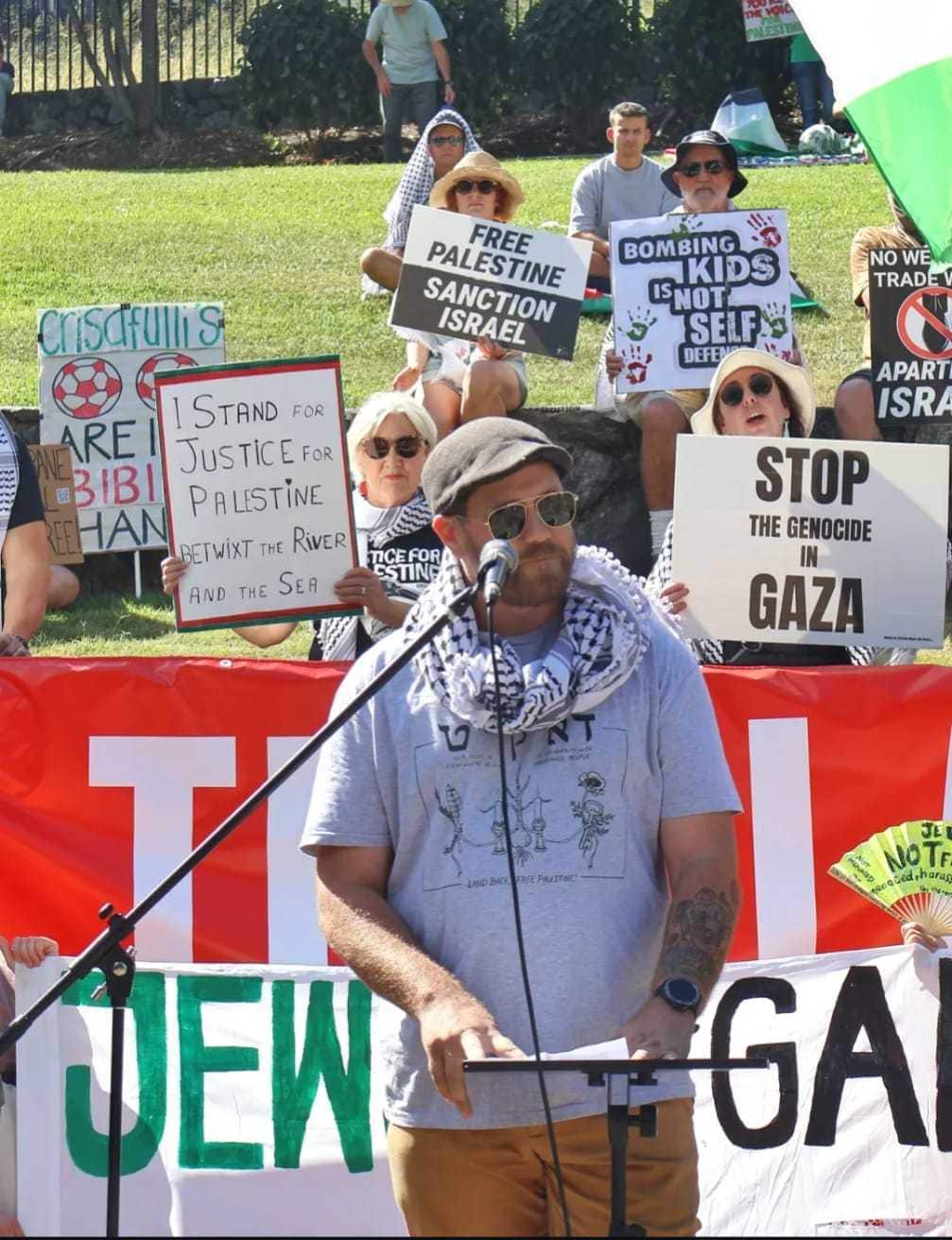 Man in front of protest signs