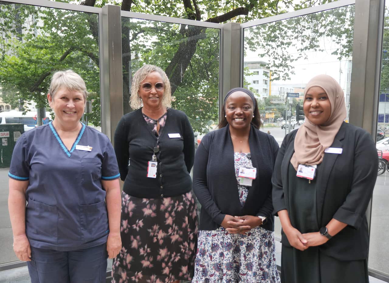 Four women standing in a line