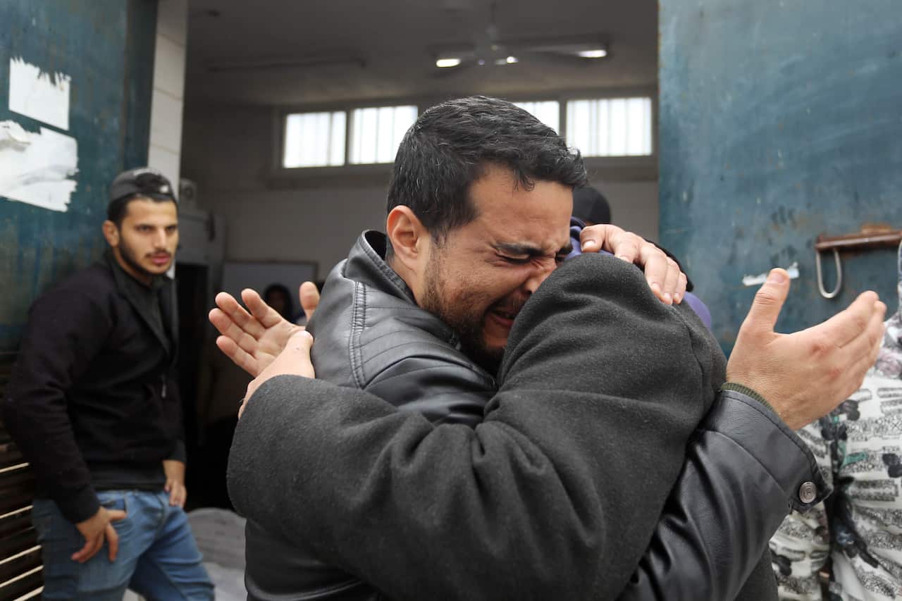Two men hugging and crying