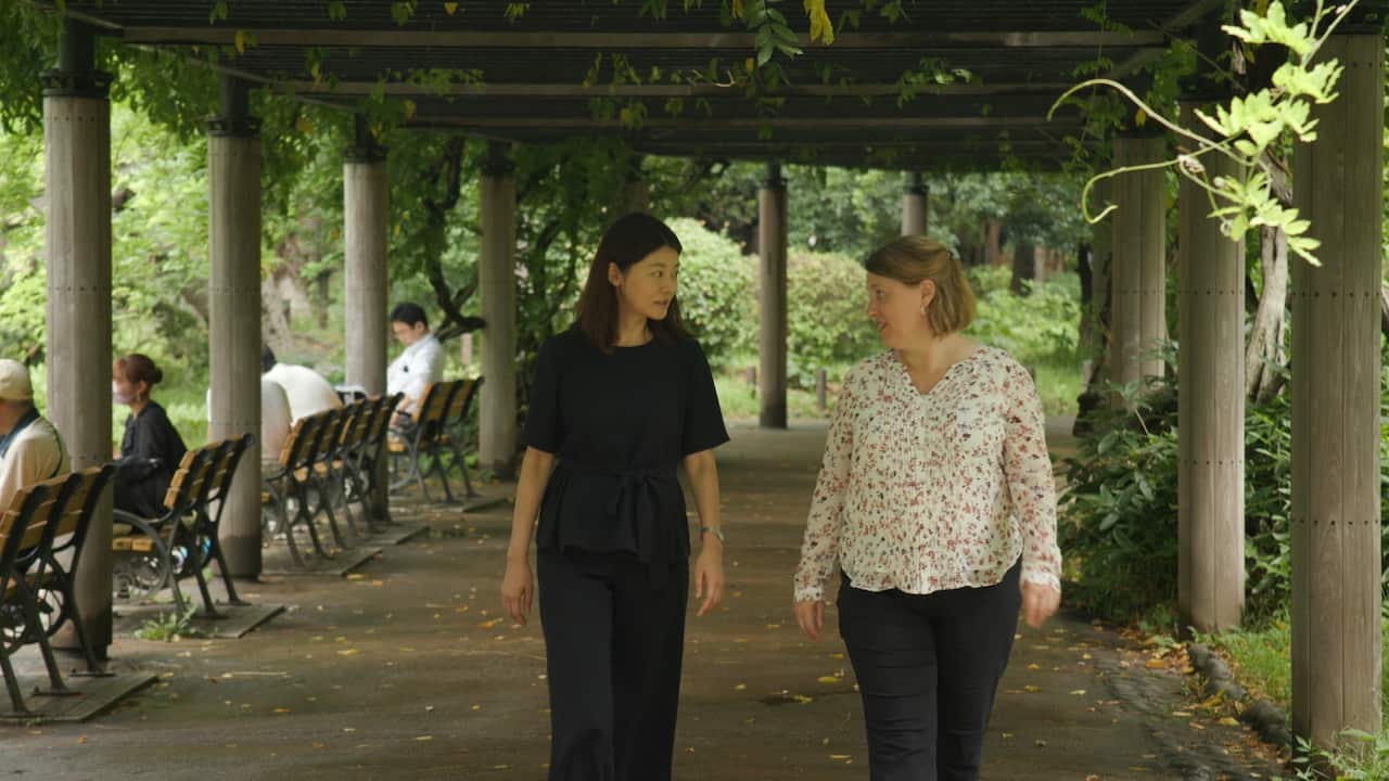 Two women walking next to eachother.