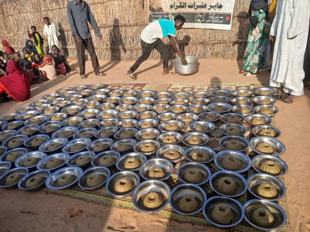 Civilians preparing meals on the floor.