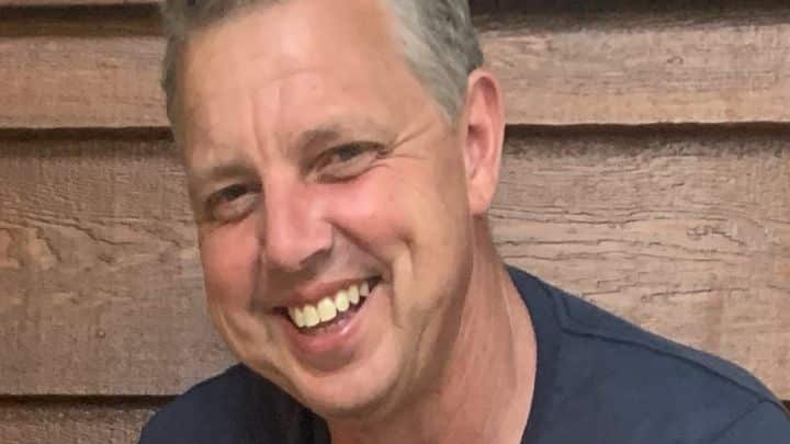 A man smiling as he poses for a photo.