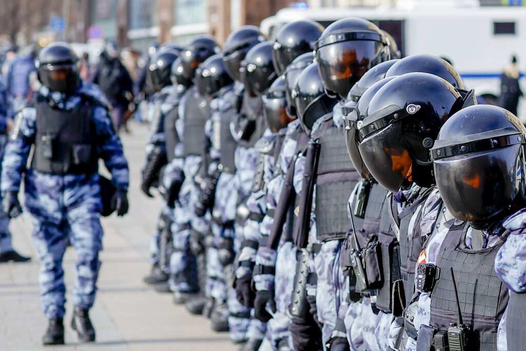 Security forces take measures during an anti-war protest in Moscow, Russia.