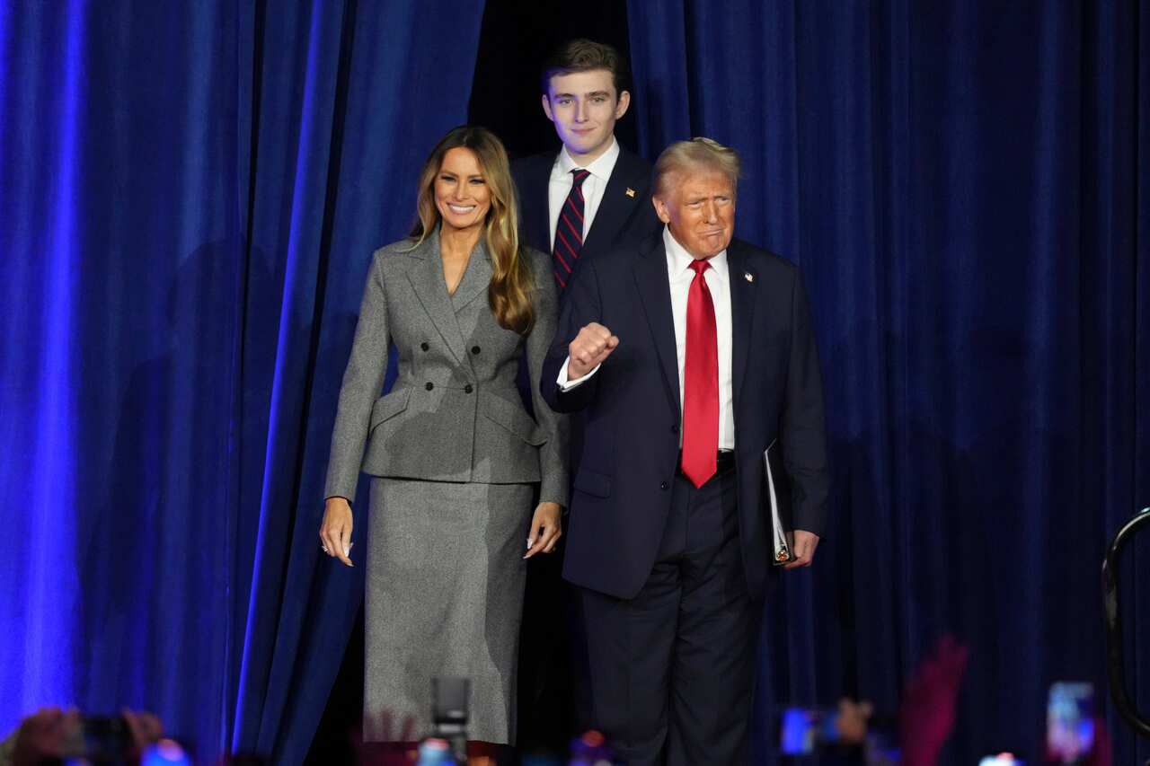 Donald Trump, his wife Melania and son Barron on a stage.