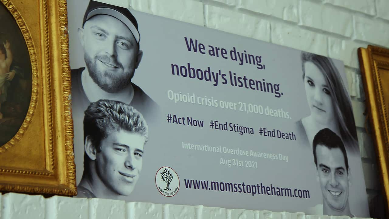 A banner for a campaign for more awareness about drug overdose shows photos of the deceased young people