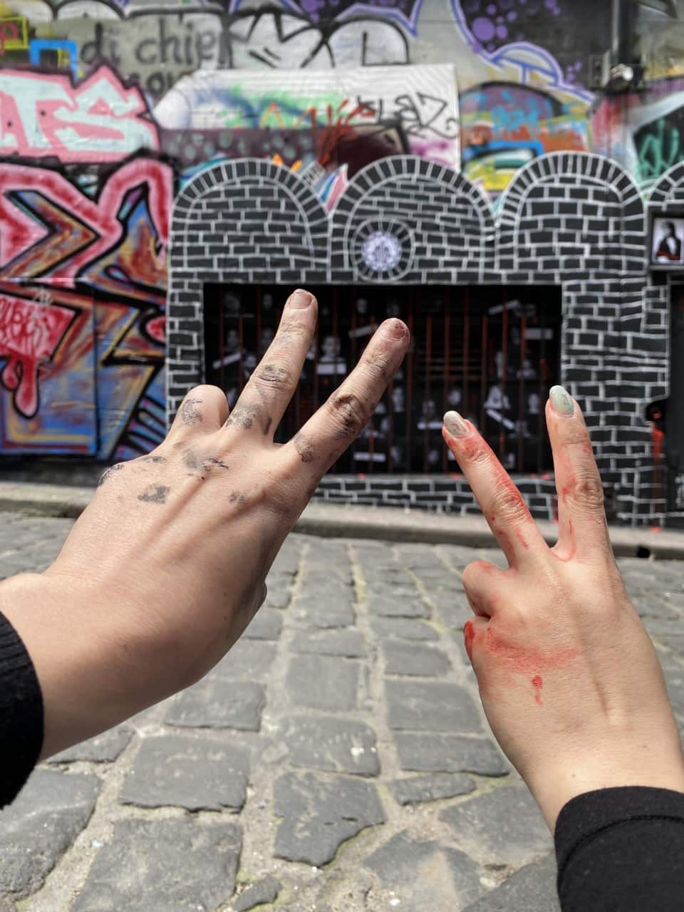 Bahar and Samaneh hands after finishing their graffiti in Hosier Lane