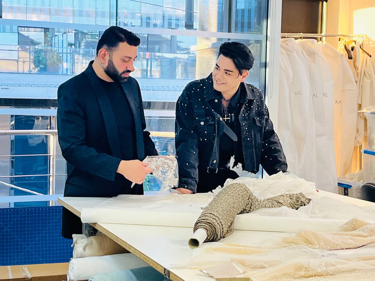 Two people looking at fabric on a table