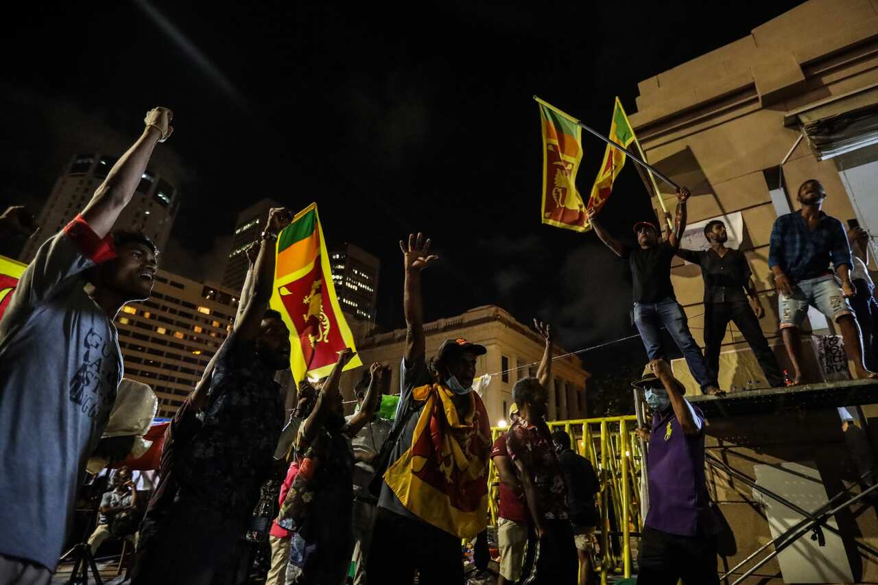 Protesters with their arms in the air.