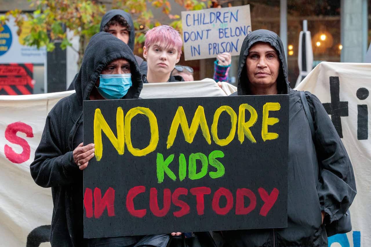 Protestors holding sign reading no more kids in custody