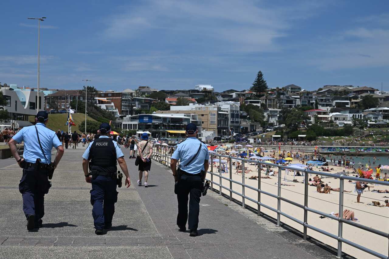 Three police officers patrolling Bondi Beach 