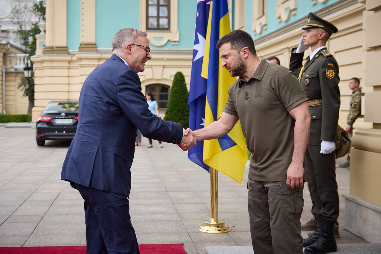 Two men shake hands. 