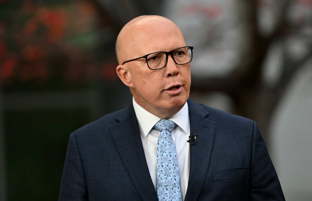 Peter Dutton wearing a blue tie and a dark suit jacket.