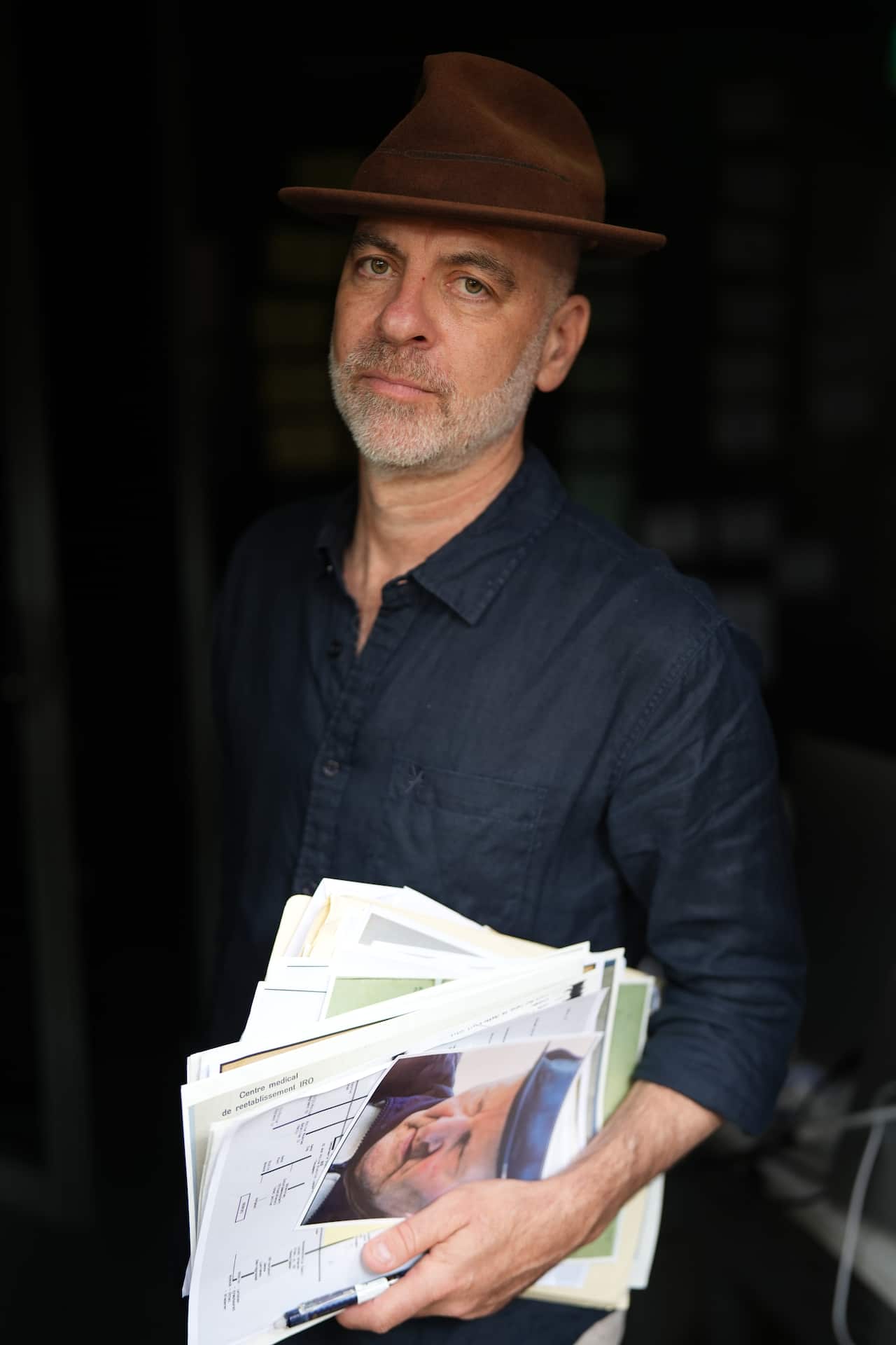 Hunt for the Last Nazis host Dan Goldberg holding papers, files and documents.