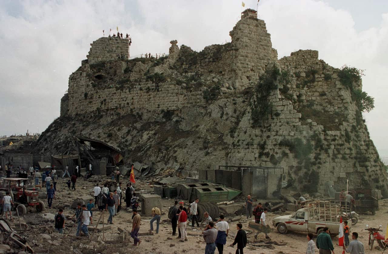 People walk around a castle