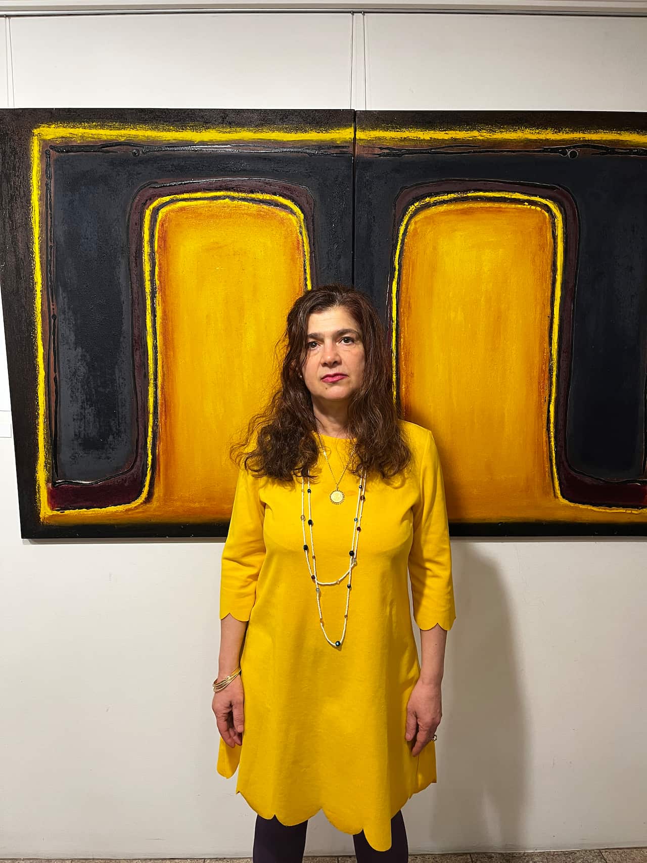 Poet Andrea Demetriou in front of her late sister, Christella Demetriou work 