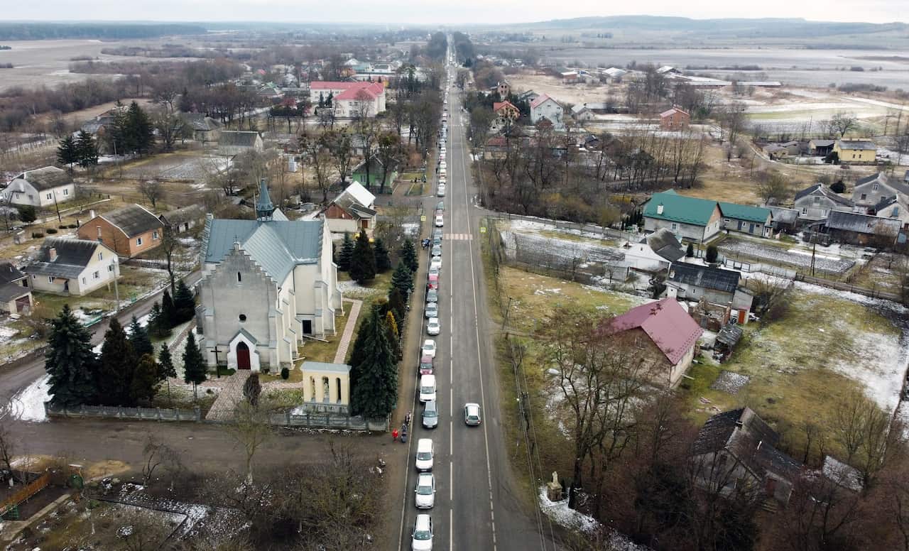 Cars stuck in traffic as families flee the conflict between Ukraine and Poland, some 20km from the border.