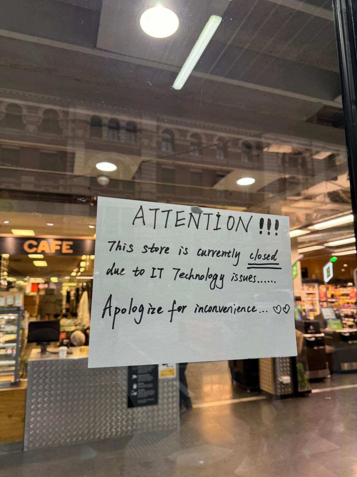A sign outside a supermarket that reads ATTENTION