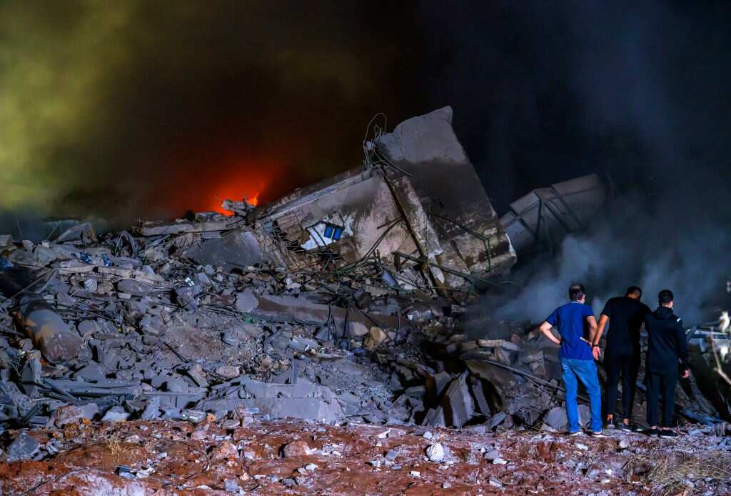 Rescue workers gather at the site of air strikes in Beirut. 