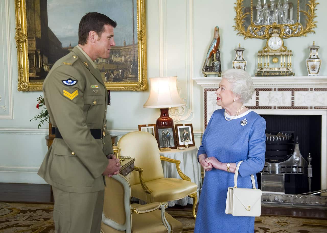 A man in uniform meeting the queen of England