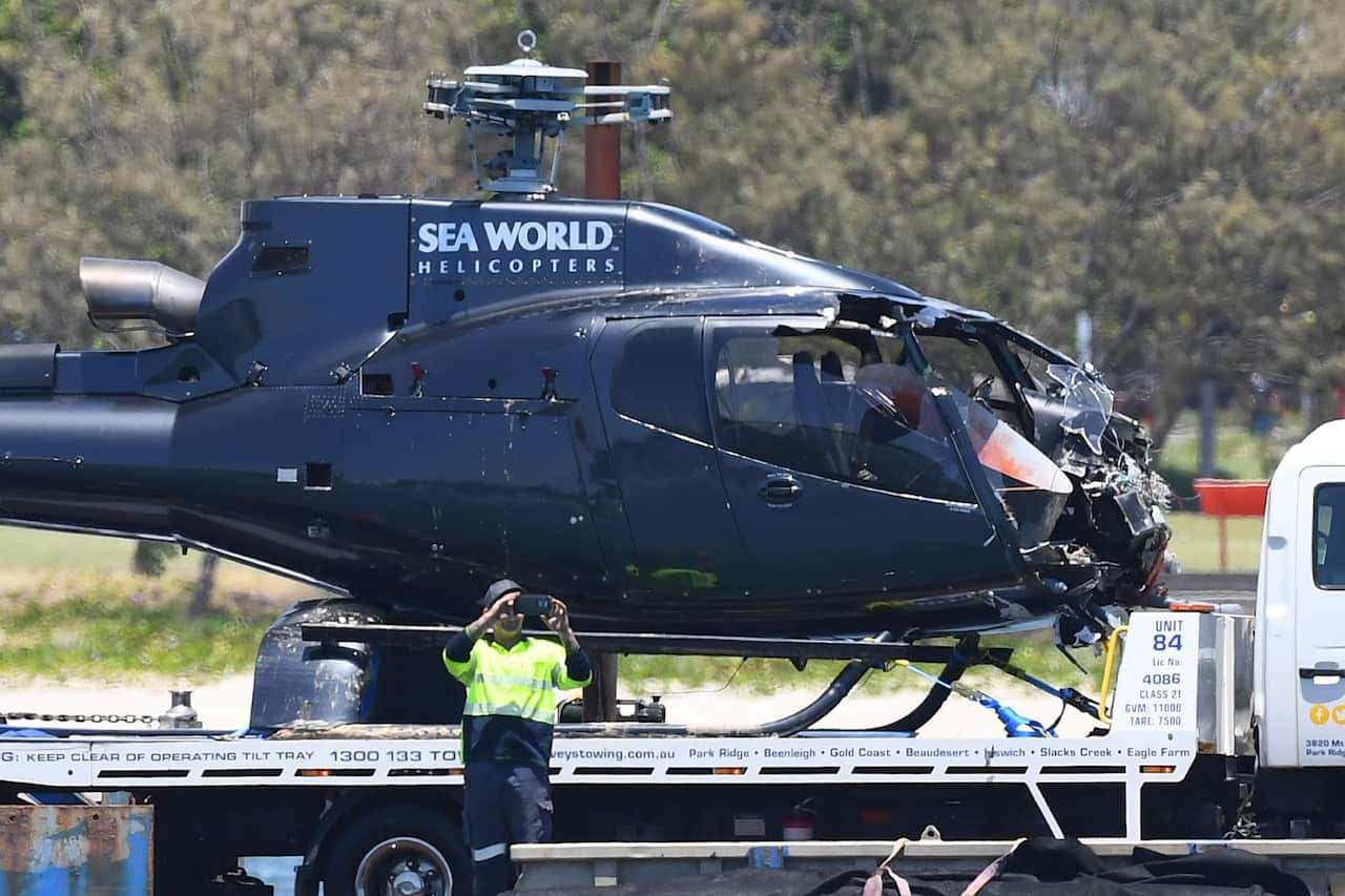 A damaged Helicopter is towed away on the Broadwater, on the Gold Coast.