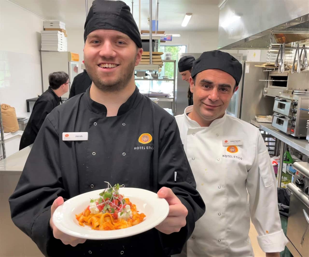Trainee Jacob McAndrew holding a plate of pasta 