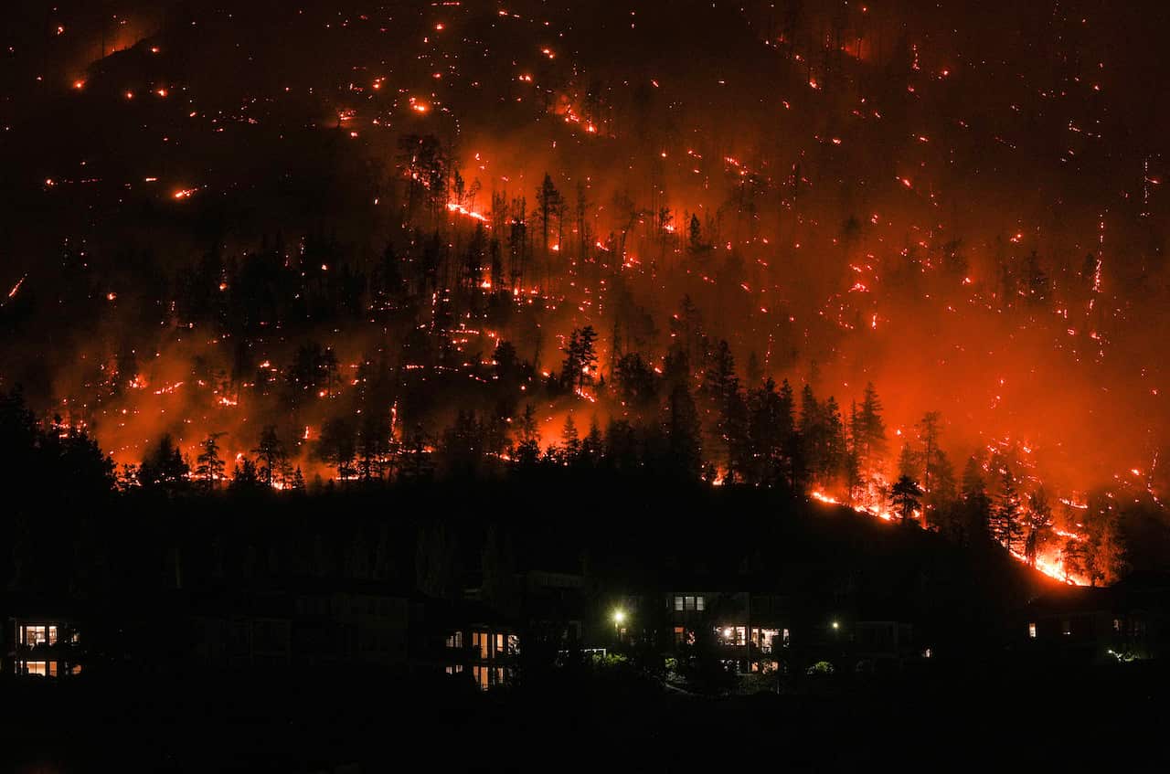 A massive blaze lights up the side of a mountain in Canada