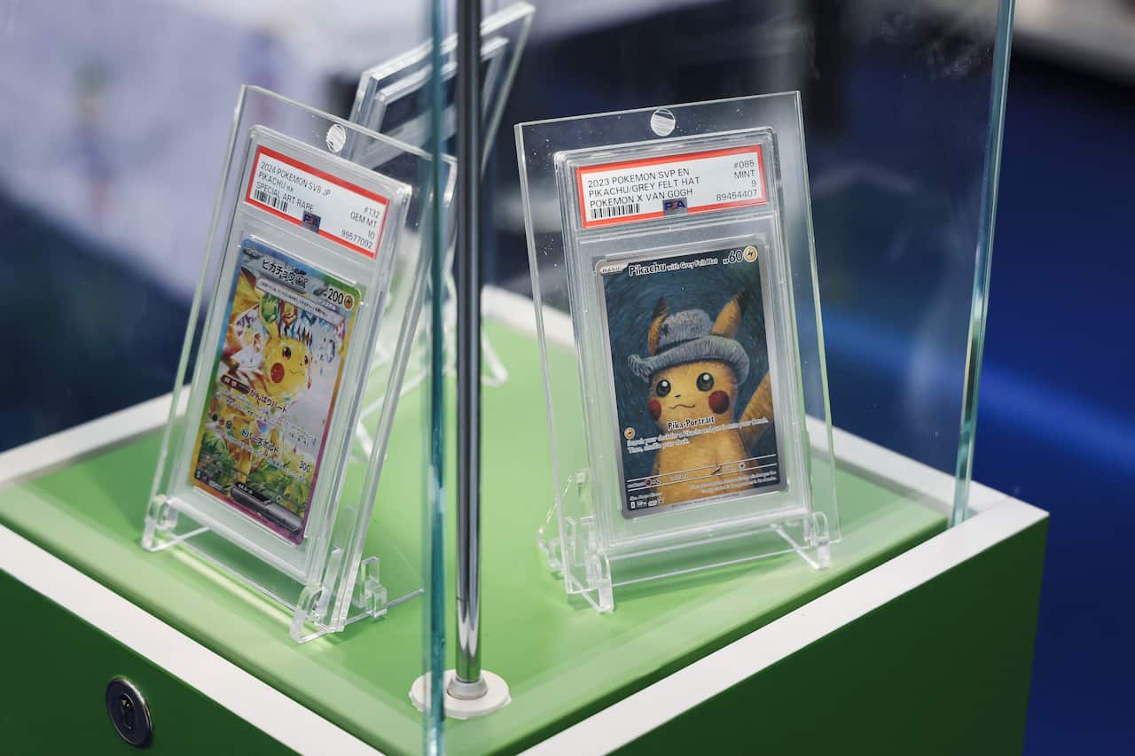 Two Pokemon cards in protective sleeves and cases.