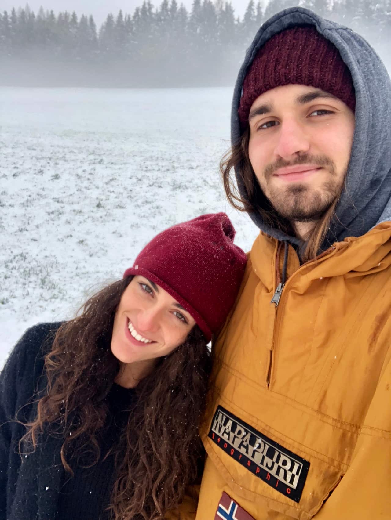Woman, named Margherita, pictured with her boyfriend, Adrian. They are standing in a snowy field.