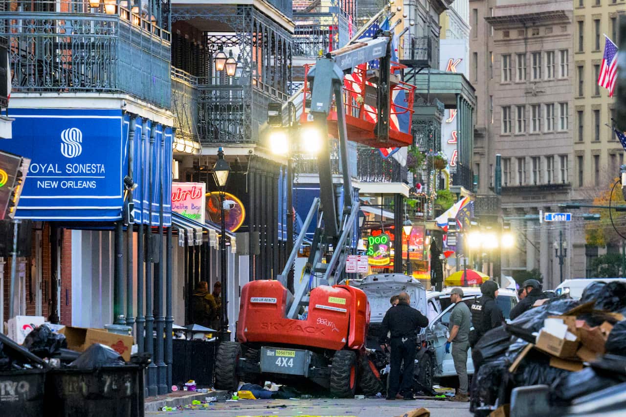 A work lift and a pickup truck after a crash with police inspecting damaged vechiles