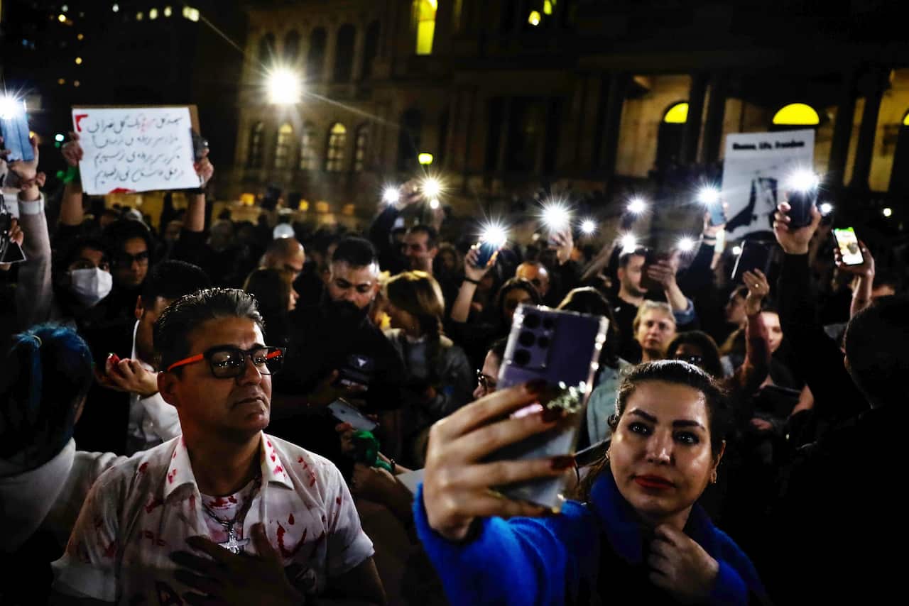 Protesters hold a vigil for 22-year-old Mahsa Amini at Sydney Town Hall
