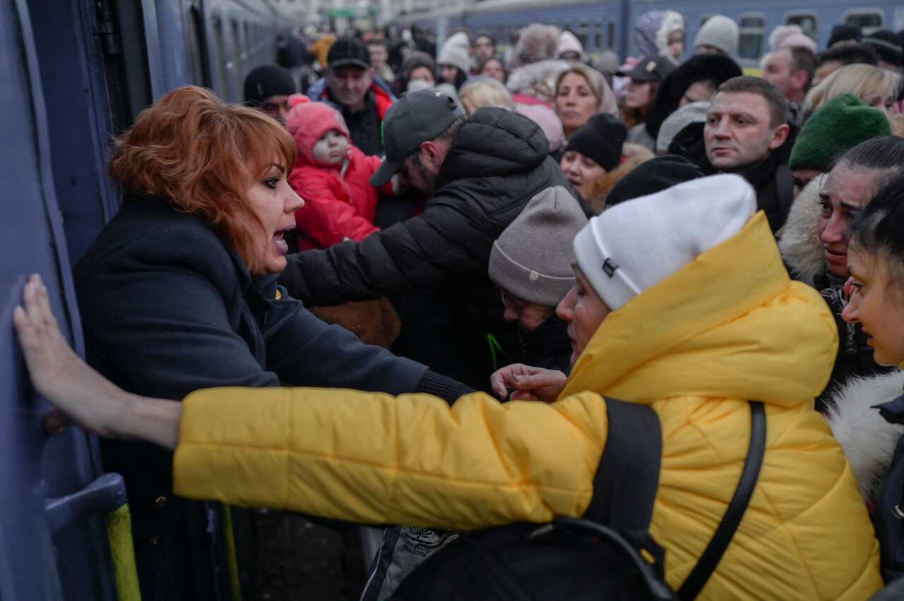 People are seen rushing to an evacuation train at the central train station in Odesa, Ukraine.