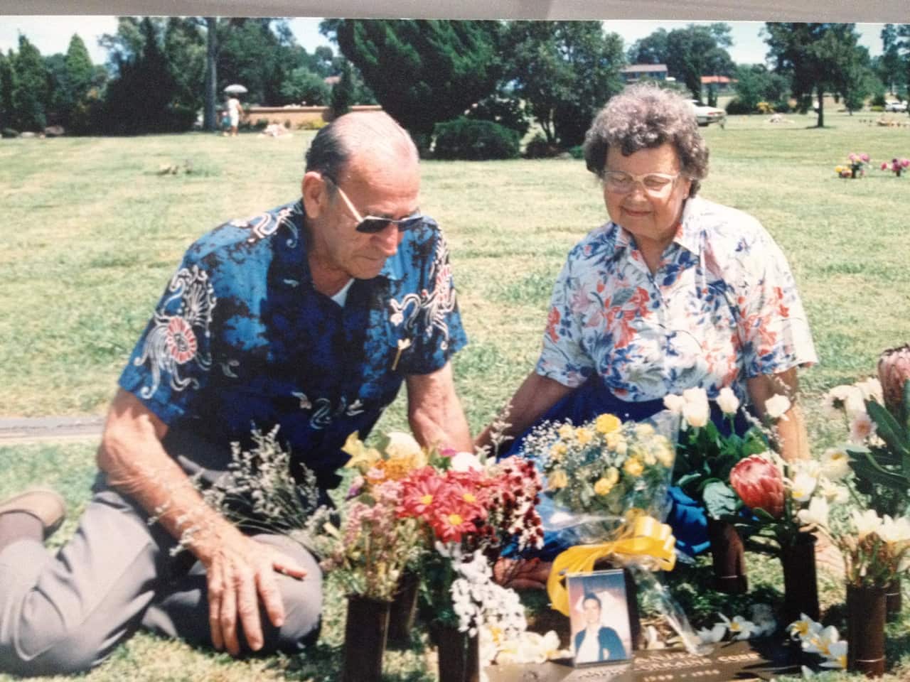 Anita Cobby's parents at her grave site with flowers on display
