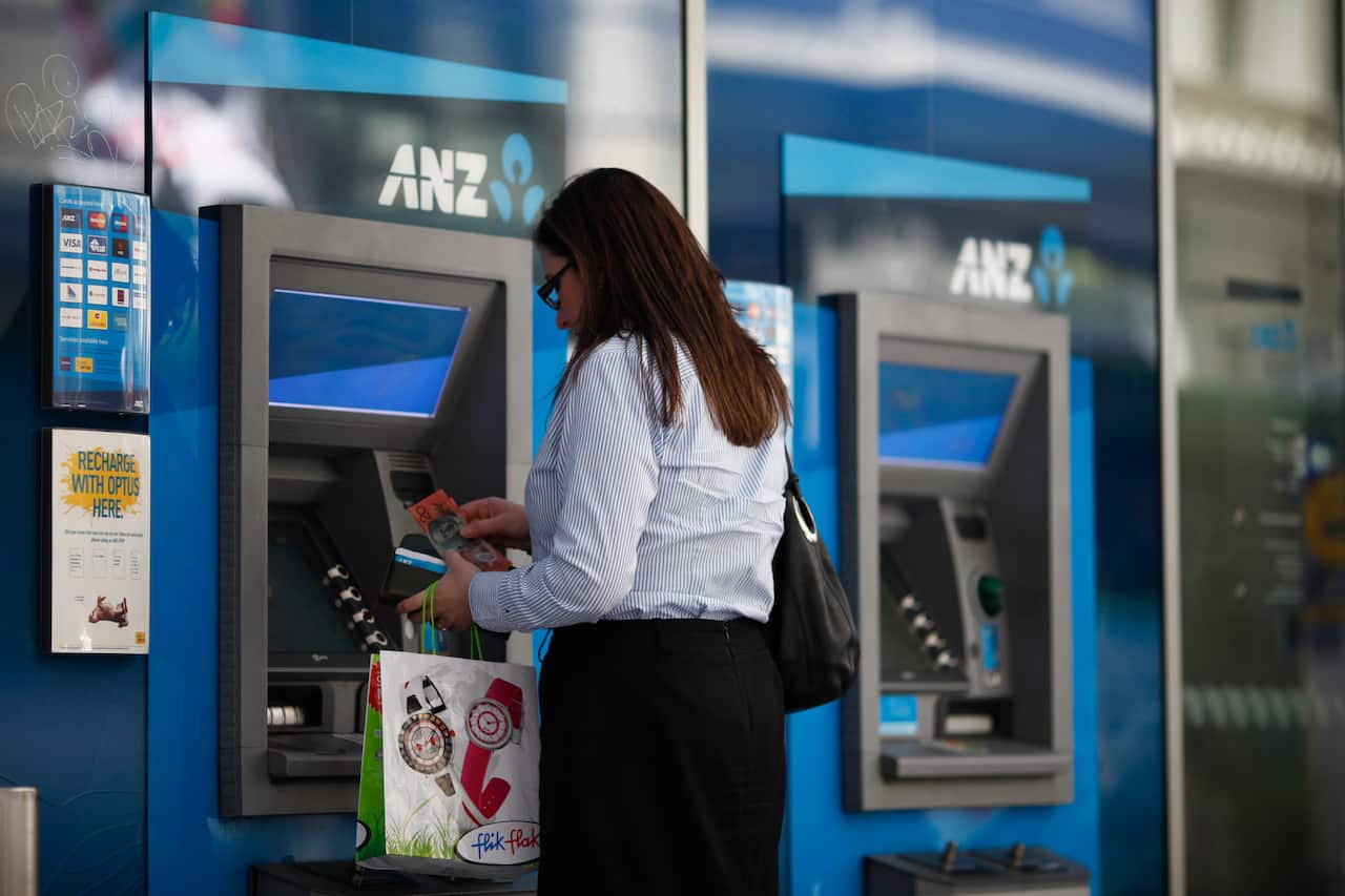 A woman withdrawing money from an ATM
