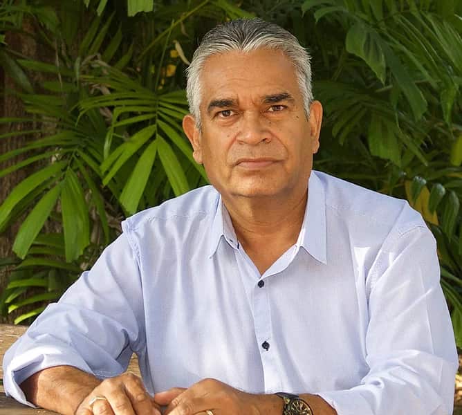 Dr Stephen Hagan, a Kullilli man from Queensland sitting in a garden. 
