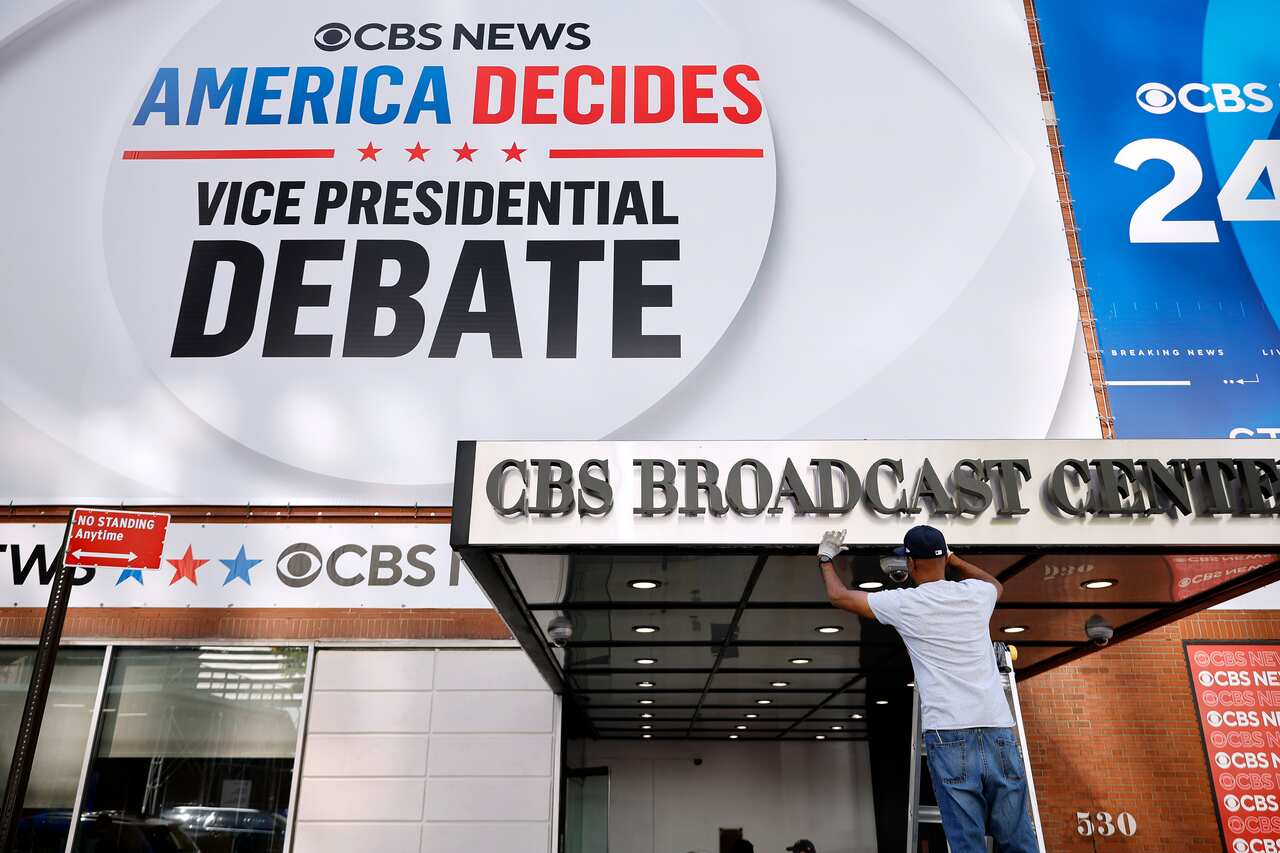 A man on a ladder in front of the CBS Broadcast Centre where the vice presidential debate was about to take place.