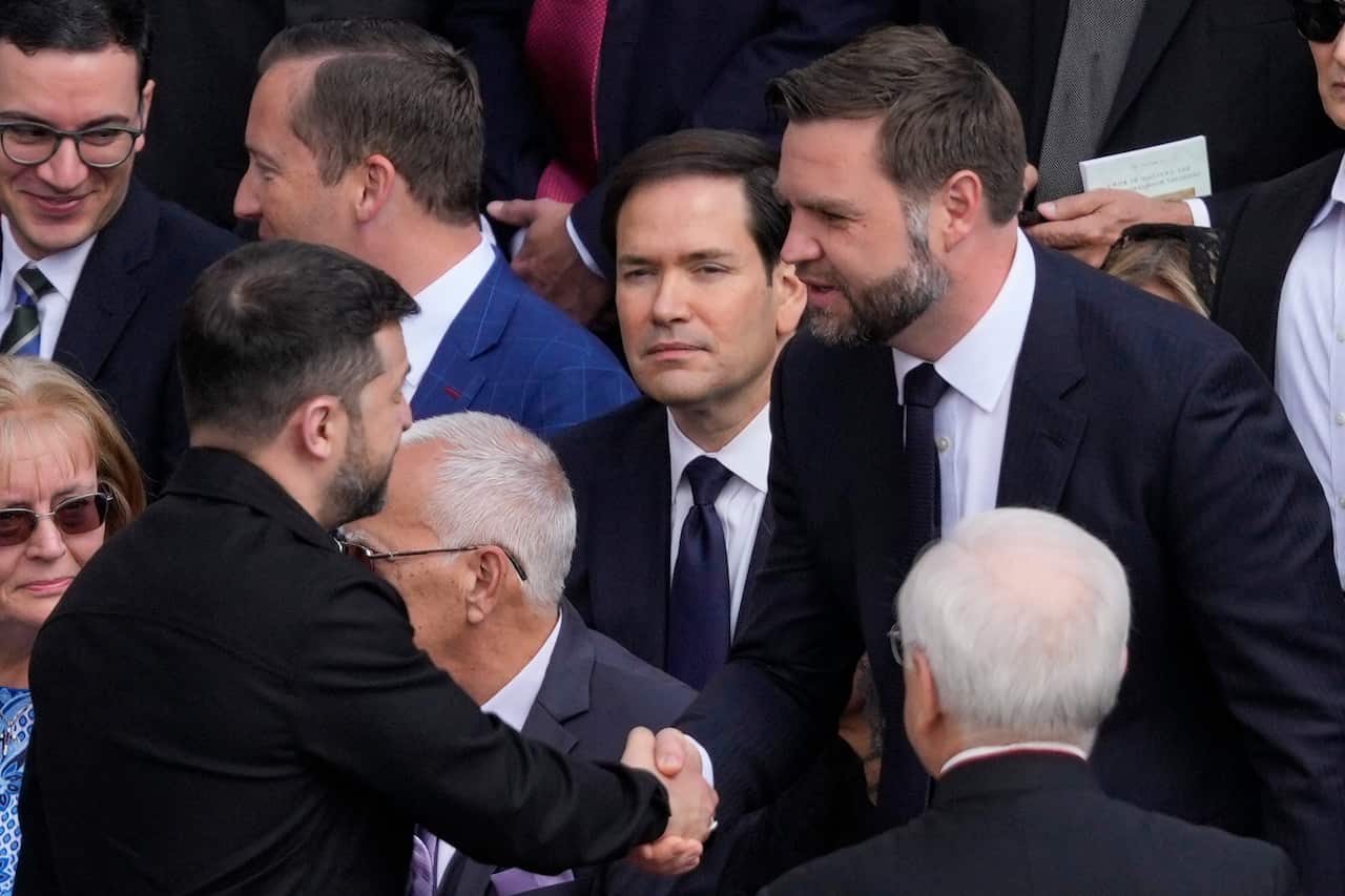 Ukraine's President Volodymr Zelenskyy, left, and Vice President JD Vance greet each other at Pope Leo's formal inauguration