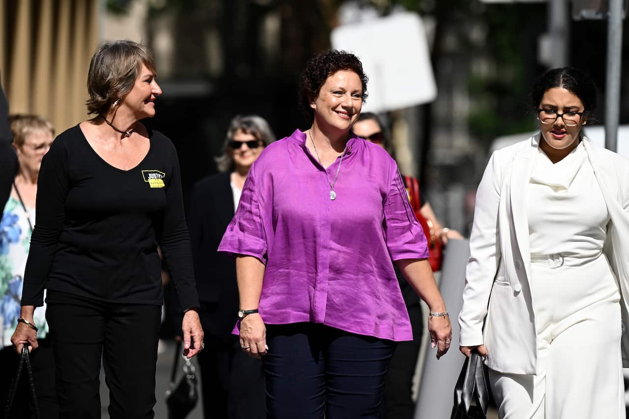 Three women walking outside.