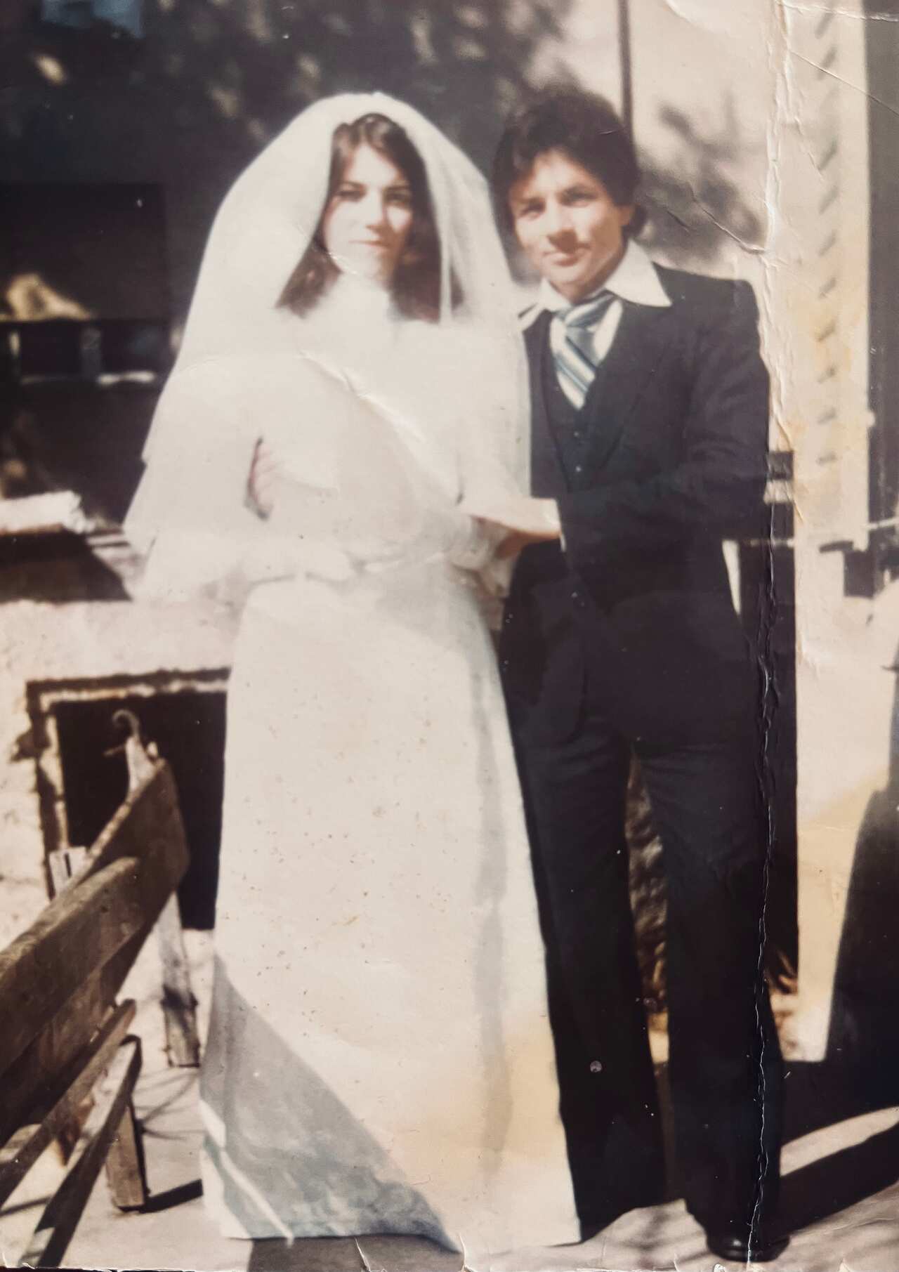 A bride and groom pose for their wedding. 