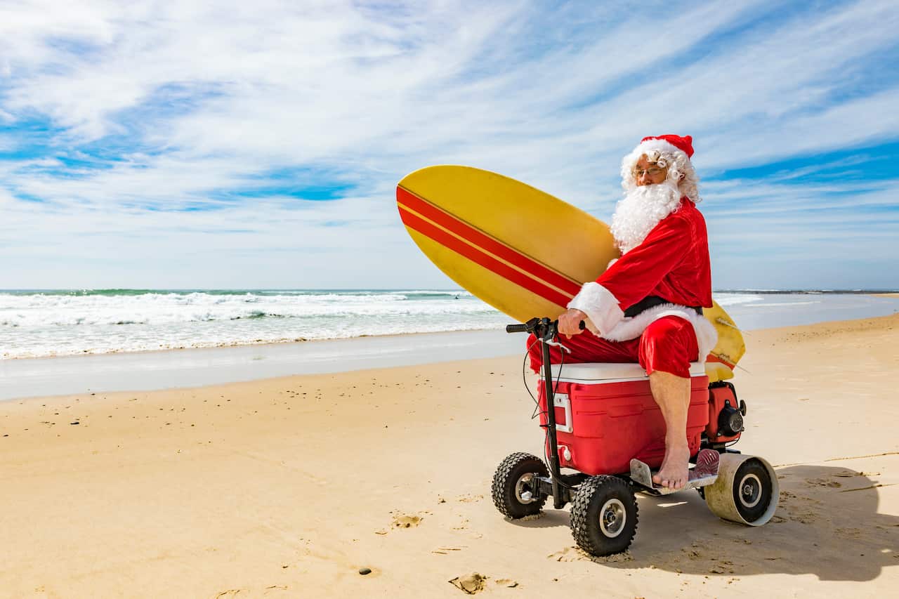 Santa Claus Riding a Motorised Esky Cooler on the Beach