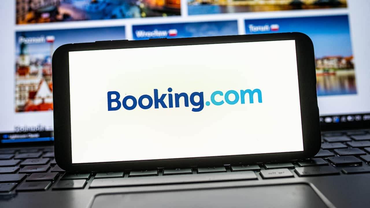 Laptop and mobile phone showing Booking.com logo 